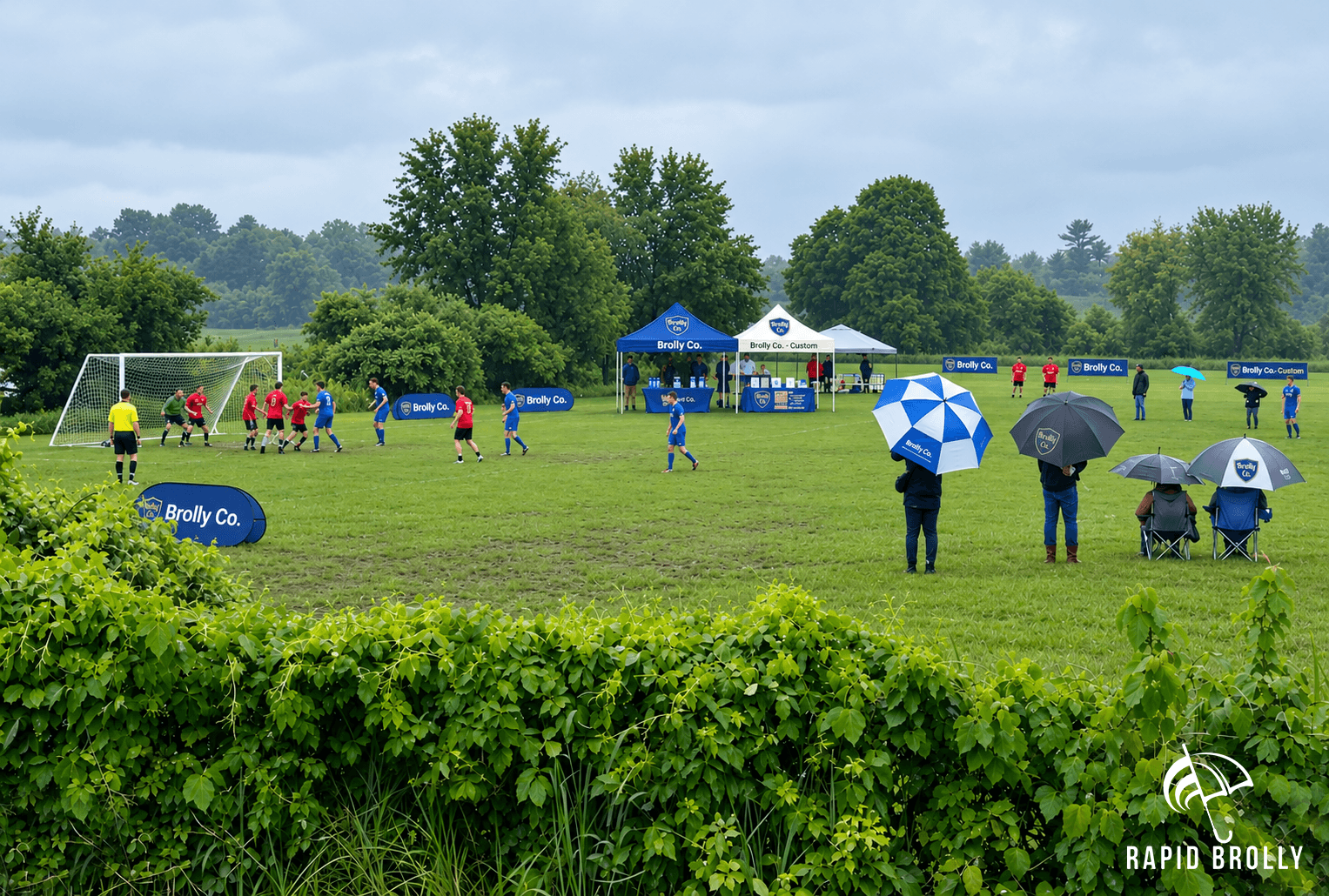 Supporters watching a grassroots football match under umbrellas in club colours.